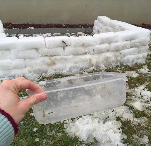Easily shape snow into blocks using a rectangular-shaped Tupperware container.