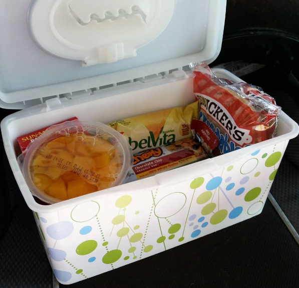 Use an empty wipes container to store travel snacks for your kid.