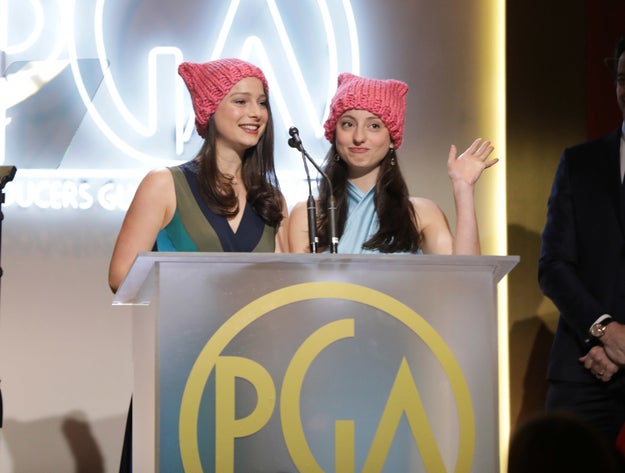 Elizabeth and Nora Rothman opted for a non-verbal form of protest by wearing "pussy hats" while presenting their father, Tom Rothman, with the Milestone Award.