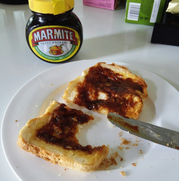 Spreading Marmite over buttered toast.