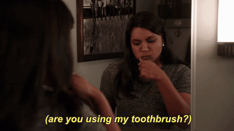 Storing your toothbrush in a closed container allows for the accumulation of moisture (yuck), which creates a very pleasant environment for growing microorganisms. You should replace your toothbrush every three to four months, and whenever you get sick. Read this article from the ADA for more details.