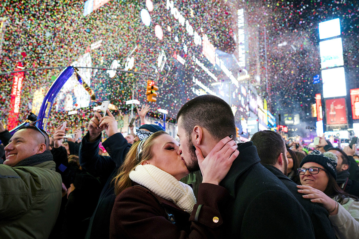 Kaitlin Olivi of Yonkers, New York, and Lucas Pereira, of Sayreville, New Jersey, kiss as confetti falls during a celebration of the New Year in New York's Times Square.