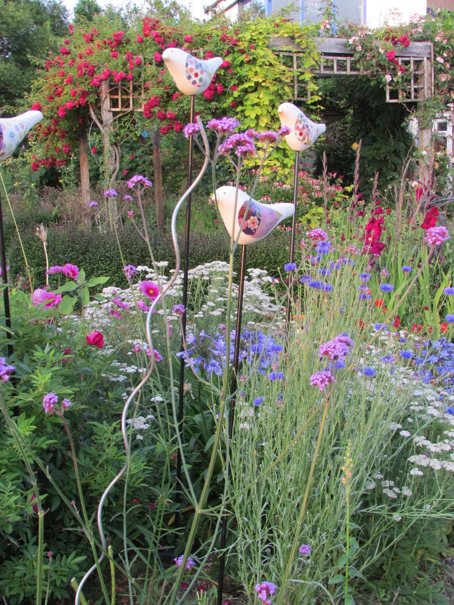 Annabel's artwork is dotted around her flower garden.