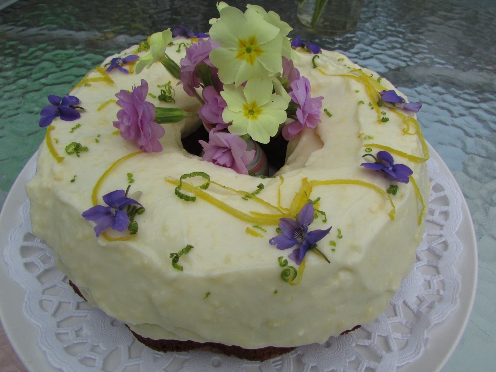 Iced carrot cake decorated with borage and primroses.