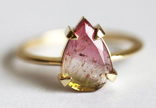 A watermelon tourmaline ring featuring what looks like suspended magical particles.