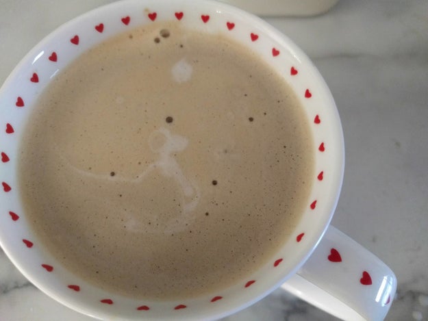 This latte's foam in the shape of Snoopy gazing at the moon.