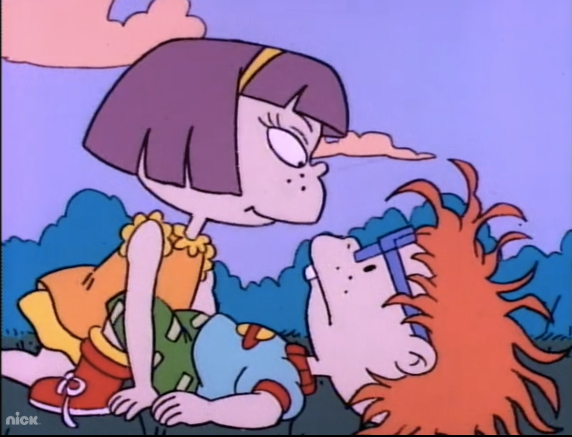 Chuckie and a girl sitting on the grass in missionary position. 