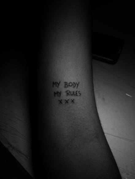 Side tattoo saying my body my rules
