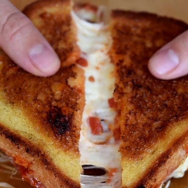 grilled cheese with pizza sauce and mozzarella cheese in it