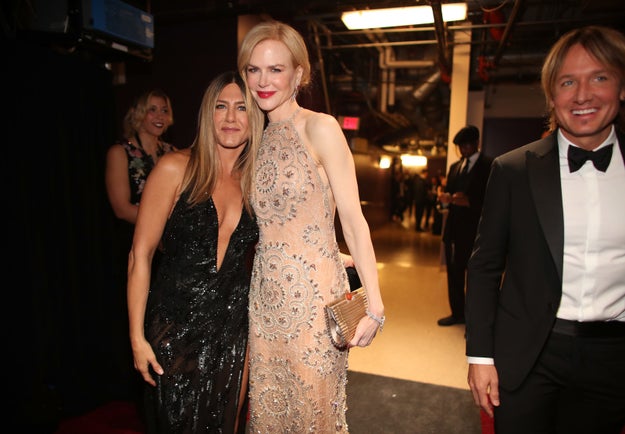Jennifer Aniston and Nicole Kidman embrace.