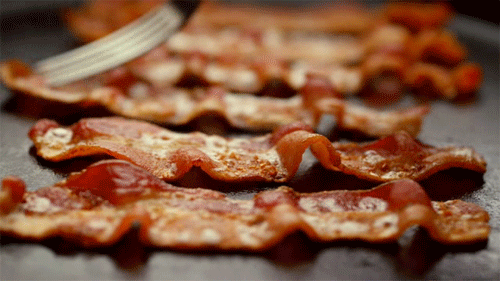Remember waking up in the morning to the smell of sizzling bacon, the sight of paper towels damp with grease and the taste of room temp strips? These food memories invoke nostalgia and surface cravings, leading to an emotional attachment so powerful it has sparked a nationwide bacon movement.Bacon Mania refers to the zealous bacon fever that has, one crunchy strip at atime, taken America by storm. Although the craze has taken a modern spin, it can be traced to 1924, when Oscar Mayer began producing packaged, pre-sliced bacon. Prior, the meat could only be found at butcheries or on menus. Armed with convenient bacon strips, Oscar Mayer became a household name. Soon enough, every home on the block was frying up bacon. It became the new breakfast staple. Children woke up to the smell and sizzling. Whether atop an egg sandwich or drenched in maple syrup, the scent wafted its way into the memories and hearts of those who grew up eating it. However, bacon's popularity was tested and its place in the American diet was questioned.Due to the Atkins diet and the surge of high-protein, low fat foods in the 1980s and 90s that transformed the American food industry, bacon got a bad rep. Robert Atkins was inspired to create the low-carbohydrate diet, the Atkins Nutritional Approach, after reading “Weight Reduction” a research paper by Alfred W. Pennington. He used the diet to control his own weight problem and decided the world needed his help. When Atkins published Dr. Atkins’ Diet Revolution in the mid 1970’s, which blamed obesity, cancer and heart issues on saturated fat and cholesterol, bacon became demonized for decades.Although bacon took a beating, baby boomers, faced with an economic downturn and in need of simple and cheap comforts, did not let the anti-fat trend stand in their way of clinging to bacon. Fueled by bacon nostalgia, these boomers, raised on bacon in a time of economic security, are now leading the Bacon Mania.We find comfort in the foods of our childhood. Celebratory cakes have gone widespread and mainstream with ubiquitous cupcake shops. Their mission: to deliver the joy and excitement of your 9th birthday party in a bite-size, gourmet flavored grab-and-go frosted treat. The grilled cheese sandwich is a childhood lunch staple and it's more popular than ever in a grown up form. Plastic-wrapped cheese singles on white Wonder Bread has transformed into cheddar and smoked gouda with cranberry chutney on sourdough. And the king of all comfort foods, bacon, is ever present on the corner diner’s menu waiting to take you back in time.The emotional pull of bacon is so strong that it attracts bacon-lovers from allover North America to come together and rejoice in their shared love for it, and they wouldn’t dare to “miss snout on it.” In 2014 alone, there are 54 bacon festivals scheduled around North America, from the Bacon Fest in Juneau, Alaska to the Bacon Bash in Cranfills Gap, Texas and even to the exciting Big Bacon Bonanza in Davenport, Iowa.Zingerman’s Deli, an Ann Arbor, Michigan institution since 1982 with a national mail order business, organizes the annual Camp Bacon. Bacon fanatics are now able to save their spot for the event, which attracts those who just want to “celebrate all things bacon-from bacon makers, producers, poets, historians and musicians,” while having fun, learning and snacking. Campers board buses on their way to pork heaven, greeted by enthusiastic counselors dressed in head-to-toe bacon costumes. An event purely powered by pork, the camp fundraises for a good cause: the Southern Foodways Alliance. While tasting and talking, “pork-centric” people get to support a charity and bond over the pork belly they know and love.“Food is the great equalizer,” celebrity chef Gordon Ramsay says. “You can bring a group of people together from all walks of life and generations, and suddenly you are all speaking a common language, having a joined experience.” The shared experience of bacon at the breakfast table has morphed into a collective American tradition. One that is perpetuated from one generation to the next by a nostalgic yearning for a simpler and happier time as our society and our world becomes faster, more complex and more contentious. This yearning has exploded into Bacon Mania, which allows the comfort of bacon to soothe you in a bar while you converse and sip on a bacon-and-gin cocktail, in the morning when you’re awoken with a start by the smell of bacon cooking in an alarm clock or at a work event, where you nervously nibble on a bacon wrapped water chestnut appetizer. Perhaps sometime soon psychiatrists will be prescribing a bacon wrapped donut a day instead of 20 milligrams of Prozac.