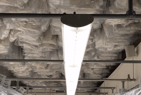 Like the kind you see at a dry cleaner. The dresses on the ceiling are ones that have already been purchased and altered and are ready for pickup. I could've stood there and watched them move around for hours.