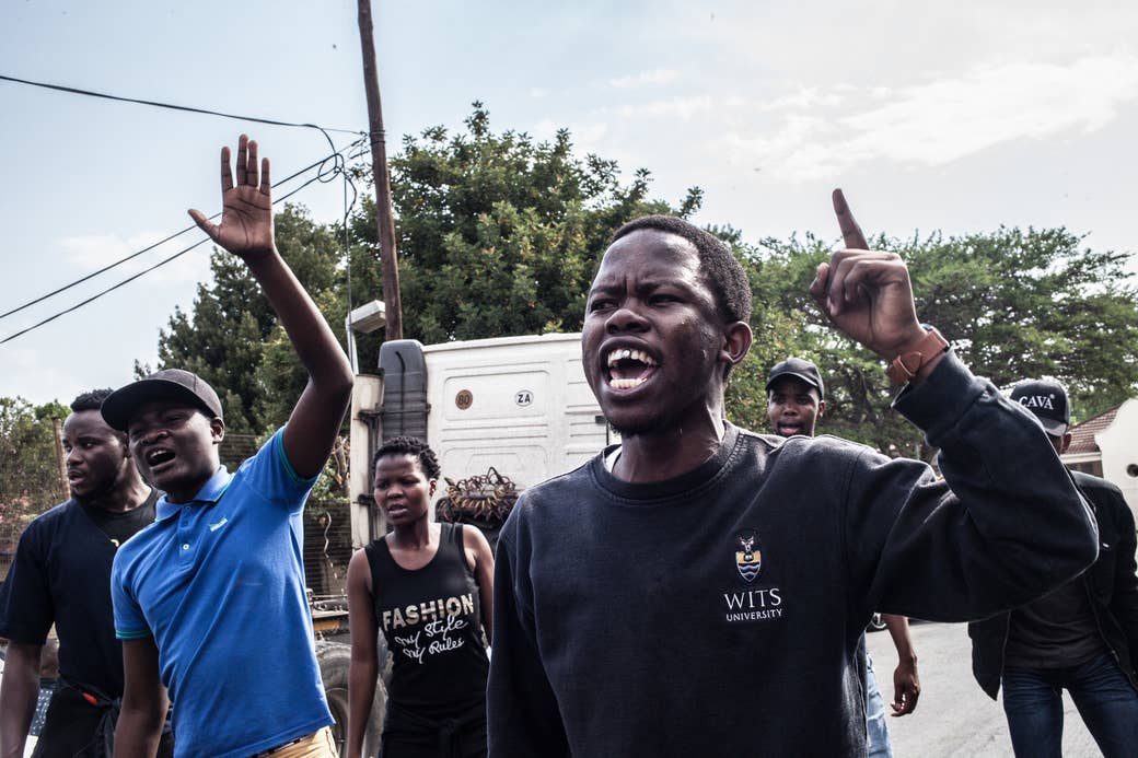 Students protest in front of the police station in Johannesburg, October 2016.