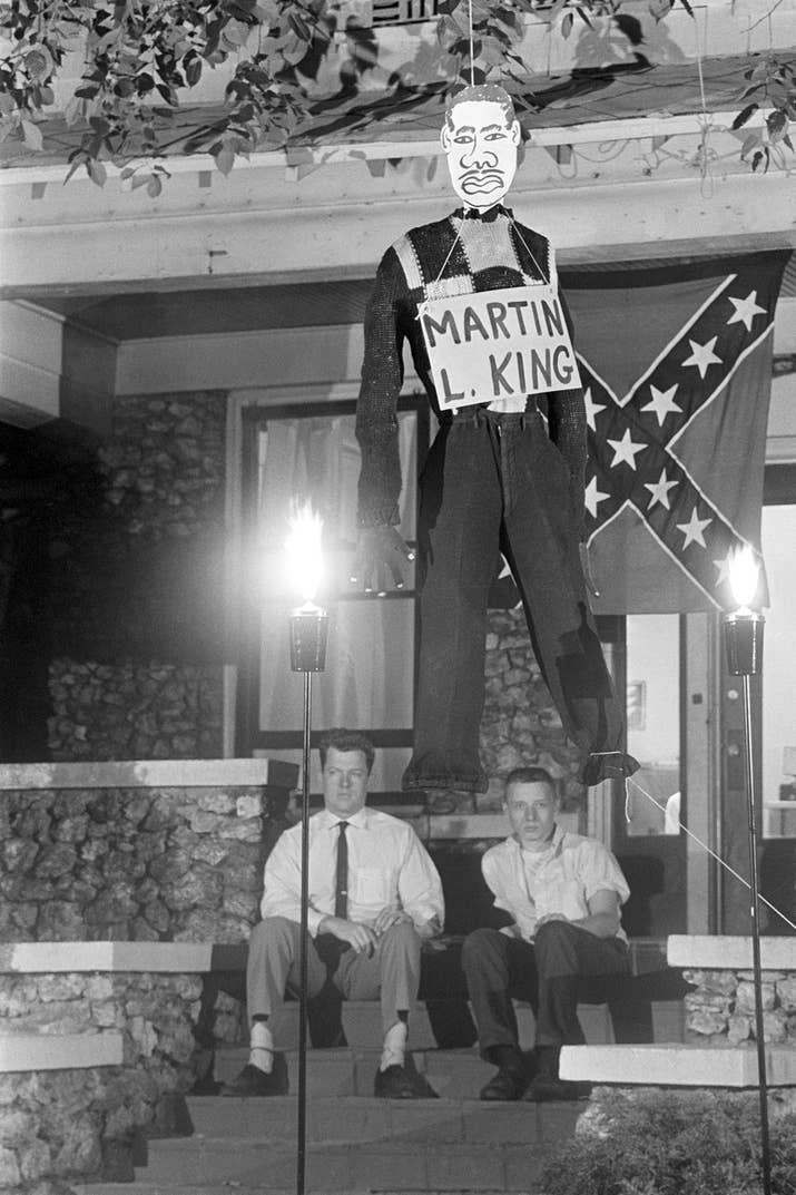 Counter-protesting against civil rights demonstrations, Edward R. Fields and James Murray, members of the National States Rights Party, hang an effigy of Martin Luther King Jr. outside the party's headquarters in Birmingham, Alabama, on May 6, 1963.