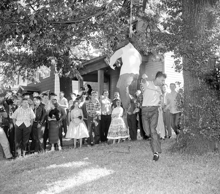 An unidentified white student slugs an effigy of a hanging black student outside Central High School in Little Rock, Arkansas, on Oct. 3, 1957, as nearly 75 students of the school walked out to protest integration.