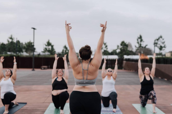 Woman plus size in gym doing exercises with running training