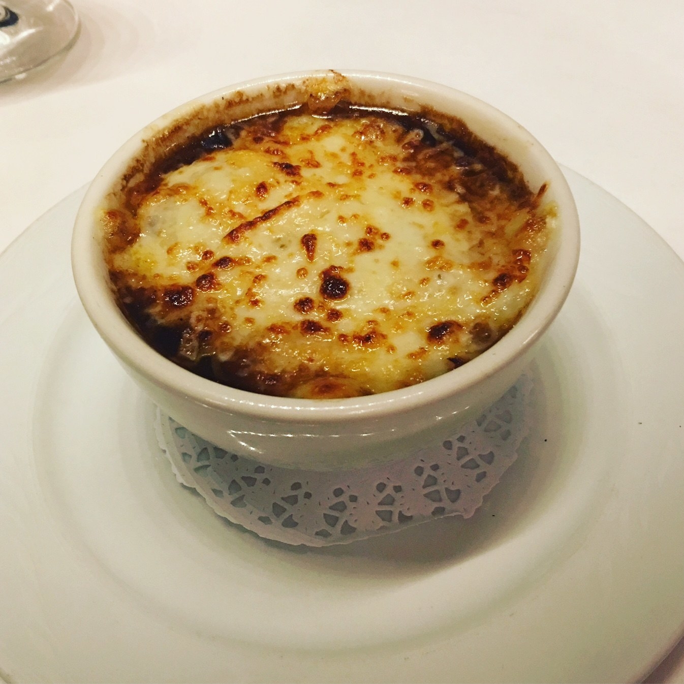 Warm your soul with this hearty bowl of French onion soup. Tpped with a generous layer of gooey cheese, the soup features rich broth with caramelized onions.