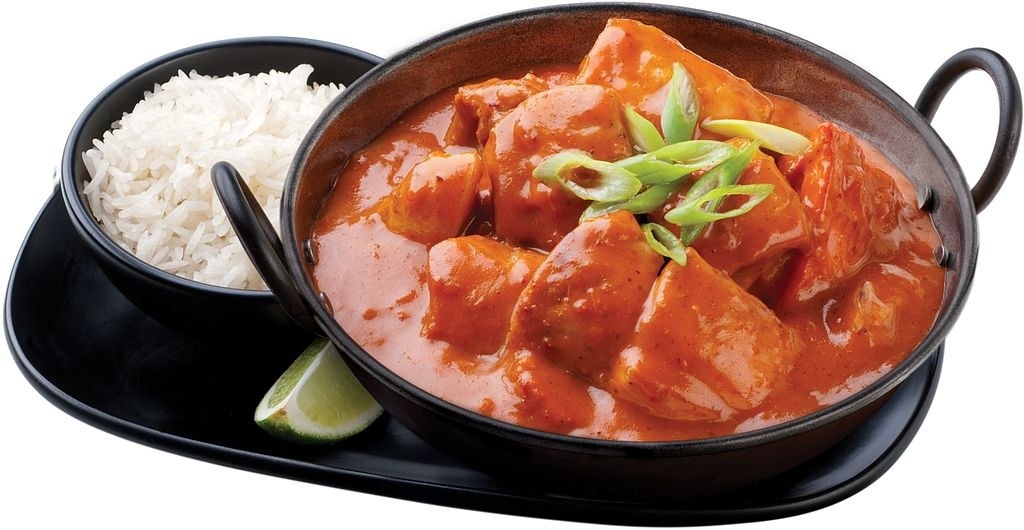 Surprisingly, Indian food has become a favourite among UK residents. In fact, there are more Indian restaurants in UK than fast food establishments throughout England! Chicken tikka masala is among the most popular dishes in UK in addition to the well-known original national dish, fish and chips. So, if you are visiting England then you need not worry about food as there are plenty of restaurants there.Indian food became more popular in UK during Victorian Era and the period of British rule over the Indian subcontinent. Because of this Indian food got to the forefront of the culinary scene. Lately a new genre of food was created called Anglo-Indian cuisine. There were nearly 10,000 restaurants serving Indian food in UK and Wales. Indian dishes in England are not entirely Indian as they are often a mix of spices and flavours. It reflects the culture of India and Britain alike and the dinners mostly combine a number of base ingredients including chicken, prawns, and other meat with a number of curry sauces. These dishes have made Indian spices household items in UK.Chicken Tikka MasalaChicken Tikka Masala is one of England’s most famous Indian dish and it is a bowl of roasted chunks of chicken in a spicy sauce. It has a creamy sauce and the recipe can vary in most cases. Ingredients6 Servings•6 garlic cloves, finely grated•2 teaspoons garam masala•2 teaspoons ground coriander•4 teaspoons finely grated peeled ginger•4 teaspoons ground turmeric•2 teaspoons ground cumin•1½ cups whole-milk yogurt (not Greek) •1 tablespoon kosher salt•2 pounds skinless, boneless chicken breasts, halved lengthwise•3 tablespoons ghee (clarified butter) or vegetable oil•1 small onion, thinly sliced•¾ cup chopped fresh cilantro plus sprigs for garnish•¼ cup tomato paste•1 28-ounce can whole peeled tomatoes•6 cardamom pods, crushed•2 dried chiles de árbol or 1/2 teaspoons crushed red pepper flakes•2 cups heavy creamMethodMix the ingredients including garlic, coriander, turmeric, ginger, garam masala, and cumin in a small bowl. Whisk yogurt, salt, and half of spice mixture in a medium bowl; add chicken and coat. Cover and chill both coated chicken and remaining mixture for 4-6 hours. Take a large, heavy pot and heat ghee in it over medium flame. Add onion, cardamom, tomato paste, and chiles and cook. Stir often, until tomato paste turns dark and onion gets soft. Add remaining half of spice mixture and cook for about 4 minutes by stirring often, until bottom of pot begins to brown. Add cream and chopped cilantro. Simmer and stir occasionally for 30-40 minutes, until sauce thickens.While that cooks, preheat broiler. Line a rimmed baking sheet with foil and set a wire rack inside sheet. Arrange chicken on rack in a single layer. Boil for about 10 minutes until chicken starts to get black in spots. Cut chicken into bite-size pieces, add to sauce, simmer the flame and stir occasionally, until chicken is cooked through. Serve with rice and cilantro sprigs.Butter ChickenButter chicken, also known as murgh makhani is another delicious dish that has spread its wings in UK. It is typically marinated overnight in a yogurt and spice mixture. The spice mixture includes garam marsala, lemon, cumin, turmeric, pepper, ginger, garlic paste, coriander, and chili. The chicken is usually cooked in a tandoor, a cylindrical clay oven used for cooking in Southern, Central and Western Asia.•lbs boneless skinless chicken breasts•1 tablespoon lemon juice•1 tablespoon Mexican chili powder •1 tablespoon garam masala•3 tablespoons butter (melted)•3 -4 drops liquid smoke•1 cup yogurt•2 tablespoons garlic paste or 6 garlic cloves•1 tablespoon lemon juice•1 tablespoon olive oil•1 tablespoon Mexican chili powder•1 tablespoon ginger paste•1 tablespoon garlic paste•2 tablespoons ginger paste•1 tablespoon butter•1 1⁄2 tablespoons garam masala•1 tablespoon Mexican chili powder•1⁄2 tablespoon honey or 1⁄2 tablespoon sugar•1 tablespoon tomato paste•1 green chili pepper (Chopped)•1 (28 ounce) can crushed tomatoes•1 tablespoon fenugreek leaves•1 cup heavy creamDirections1.Place cubed chicken in a nonporous bowl with yogurt, chili powder, lemon juice, salt and liquid smoke. Refrigerate it for at least an hour.2.Mix in garam masala, garlic, butter, chili powder, lemon juice, ginger paste, and oil. Remove the cover and refrigerate for another 3 to 4 hours to marinate.3.Preheat oven to 400°F (200°C).4.Place chicken on an oven sheet and bake in preheated oven for 20 minutes.5.Make sauce by melting butter in a large pan over medium heat. Stir in 1 tbsp garam masala. Mix in ginger, garlic paste and green chile peppers, when masala begins to puff and bubble. Saute for 5 minutes, then stir in tomato puree, chili powder, 1/2 tbsp garam masala, tomato paste, salt, and a couple more drops of liquid smoke. Bring it to a boil; reduce heat to low and simmer, stir in fenugreek, honey, and cream.6.Place chicken and pan drippings in sauce mixture. Simmer on medium-low heat for about an hour or until liquid is reduced by 1/3.7.Add salt to taste and garnish the dish with fresh chopped cilantro (optional).Rogan JoshRogan Josh is a lamb dish of Persian origin and its name roughly translates to “cooked in oil at intense heat.” It was originated in Kashmir and other areas in and around India.Ingredients•1 teaspoon fennel seeds powder•2 tablespoon garam masala powder•5 tablespoon ghee•2 teaspoon cumin seeds•1 pinch asafoetida•3 pinches black pepper•1 teaspoon dried ginger powder•750 gm chopped chicken breasts•2 teaspoon red chilli powder•1/2 cup yoghurt (curd)•1 piece cinnamon stick•2 red chilli•salt as requiredMethod•Take a deep bottomed pan and heat ghee in it. Add all the spices and stir fry till it begins to release fragrance.•Now add chicken pieces and cook covered for 5 minutes. Now whisk the youghurt and add chicken.•Add all the powdered spices and cook till the moisture is absorbed. As the chicken cooks fast keep the flame high and the chicken would get crumbly if left covered for long.•Fry till the oil separates. Add a cup of water and allow it to simmer.•Add some more red chilli powder and salt if required.•Remove the pan from fire and garnish as per your choice. Serve hot with naan and steaming rice.Malai KoftaMalai Kofta is the vegetarian version of meatballs and it is often served with naan bread or Jeera rice. Although the dish is typically cooked only for special occasions, many Indian restaurants in England serve this on a daily basis.Ingredients•4 big potatoes, boiled•1 Tbsp coriander leaves, chopped•3 onions•250 gm paneer (cottage cheese)•50 gm maida•200 ml malai or cream•2 Tbsp raisins and cashew nuts•1/2 tsp haldi (turmeric)•1/2 tsp red chilli powder •50 gms cashew nuts paste•1/2 tsp kitchen king masala•1 Tbsp kasturi methi (dry Fenugreek)•Salt to Taste •1 Tbsp ginger garlic paste•2 tomatoes•1Tbsp sugarMethodFor the koftas: 1.Refrigerate the boiled potatoes for 4 to 6 hours so as to make cooking easier.2.Mash the boiled potatoes, maida and paneer. The mixture should not be too soft or too hard. Add salt, chopped coriander leaves and mix well. 3.Cut the cashew nuts and raisin into very small pieces and add 1/2 tsp of sugar to the mixture.4.Heat up the oil to deep fry. 5.Make balls from the dough you prepared and stuff the dry fruit mix in the centre.6.Deep fry the koftas and dust them with dry maida before putting them in so that they do not break in oil.For the gravy:7.Fry some ginger garlic paste, onion, and tomato paste.8.Mix the cashew nut paste with 2 Tbsp of warm milk and mix it into the paste. 9.Add all the dry spices into the paste except kasturi methi and saute till the oil separates itself.10. Add a half cup of water and simmer the gravy till it is cooked. 11. Add cream, 1 Tbsp of sugar and kasturi methi.12. Simmer the gravy till the oil starts separating. Put the fried koftas into the gravy and serve hot. Other popular Indian dishes include Golgappa (view golgappa recipe) or Panipuri, Naan (Indian bread) and Biriyani which are mostly accompanied with the above three star curry dishes.