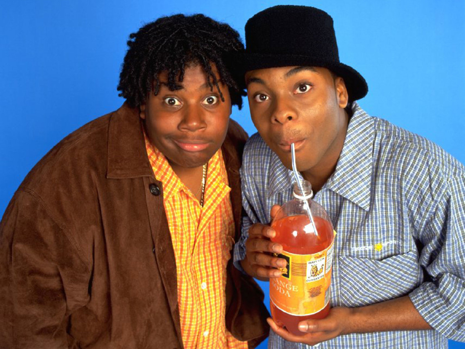 Two people posing with soda