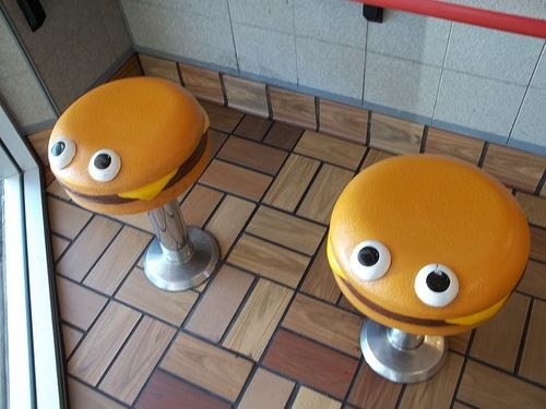 restaurant bar stools that look like cheeseburgers with eyes