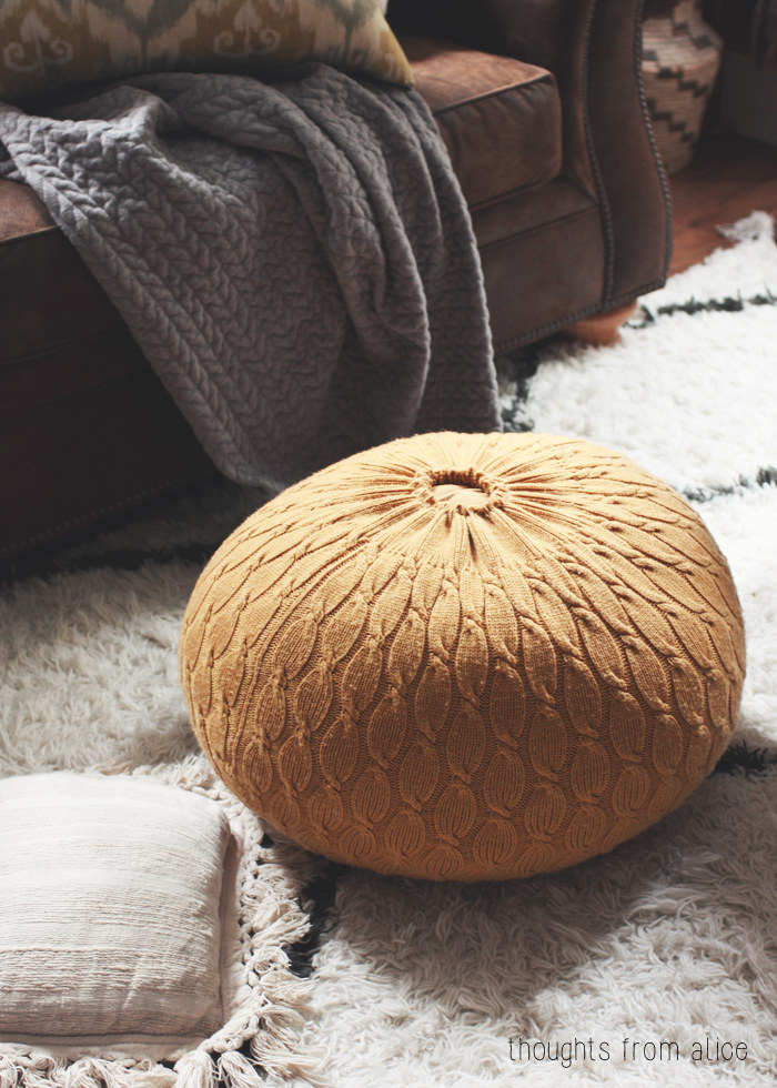 the orange pouf ottoman made from an old knit sweater