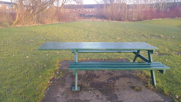 The picnic bench that has an overhang for wheelchair users.