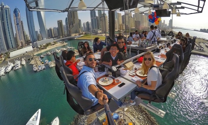 Have you ever eaten a meal while suspended in thin air? And no, I'm not talking about that bag of 6 peanuts you ate on your last flight to Hawaii. Well, a company called Dinner In The Sky wants to take you to new heights with their traveling dining opportunities. The group is bringing the experience to major cities around the world and sets their table high above the skylines of these metropolitan areas. That's right! The banquet table set for 22 is hoisted up in the air by a massive 150-foot crane. The trend began in Brussels, Belgium, but has since expanded to places such as Toronto, Dubai, Tokyo, and Paris -- to name a few.