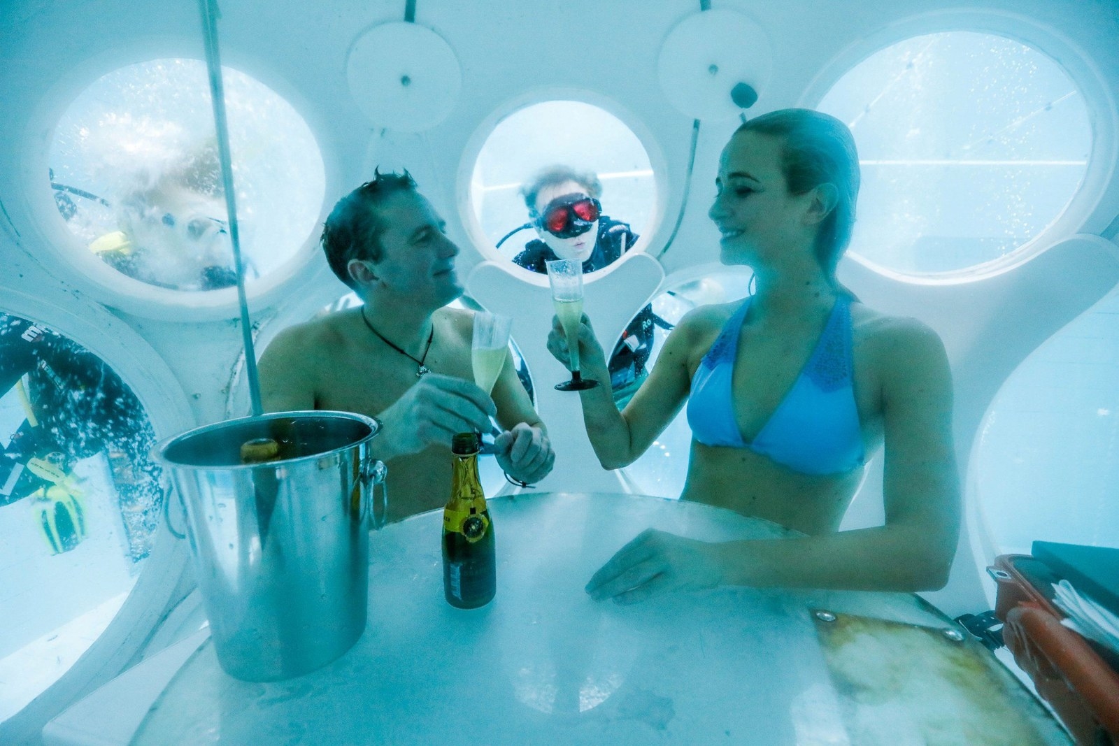 Take a look at this catch of the day! The Pearl Restaurant located in Brussels, Belgium brings a whole new meaning to the saying "blue plate special". Nearly everything has a hint of blue at this dazzling dive, because the restaurant itself is located nearly 20 feet underwater. Guests are given private tables inside of cozy water-tight capsules, and meals are served by a charming school of scuba diving waiters and waitresses. This fine diving experience (see what I did there) can be enjoyed at Brussels' Nemo33 Diving Center.