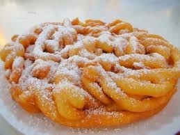 Fried dough that has a crispy texture and is covered in powdered sugar.