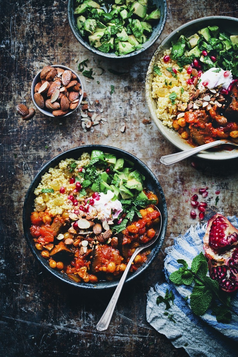 bowls of eggplant and chickpea stew with couscous and salad
