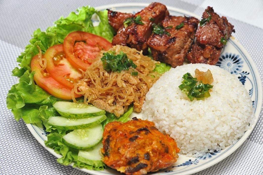 Com Tam, or Saigon style broken rice is an interesting combination of white rice, with your choice of grilled meat (typically pork), pickled carrots/daikon radish, cucumber, fried thinly shredded pork with pork skin, and a fried egg or a slice of Cha Trung or what I call Vietnamese "meatloaf."