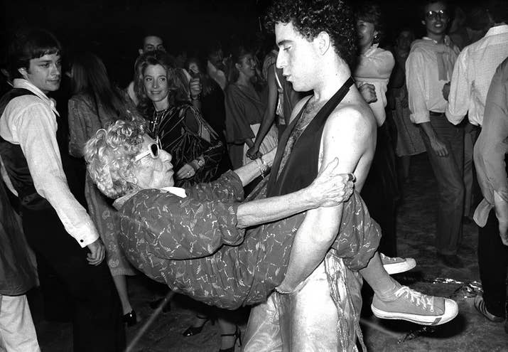 A woman known as "Disco Granny" dances with a young man at Studio 54, circa 1978.
