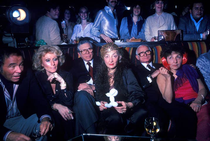 A group of older men and women relax on the sidelines of a disco club in New York City in 1978.