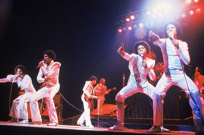 The Jacksons perform during a concert, circa 1975.