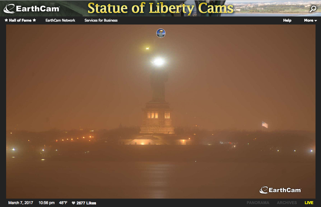 Web cameras that normally show the Ellis Island icon fully illuminated by 10:30 p.m. Tuesday showed only her torch and a handful of other lights.