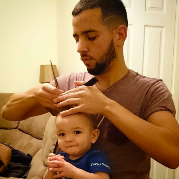 Father uses a spoon to give his son a haircut