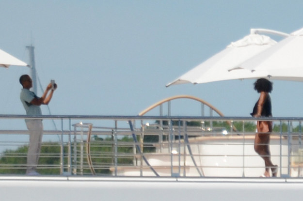 He and Michelle were caught on the deck of the yacht the Rising Sun on Friday, where they're chilling with cool friends Oprah Winfrey and Bruce Springsteen in French Polynesia, NBD.