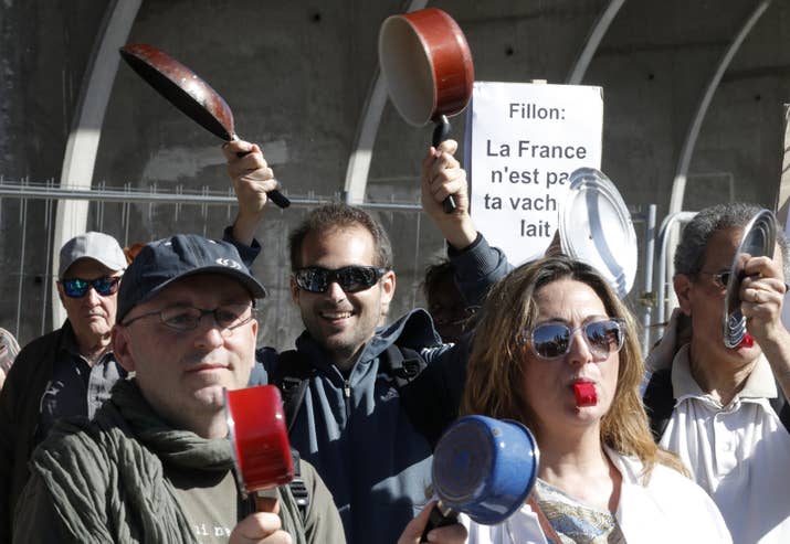 This type of arrangement is so common in France, where it is somehow not illegal for politicians to employ their spouses and children in ~real~ jobs, that there's a term for it: emploi fictif, or fictional employment. BuzzFeed News also found that two of Fillon's assistants appear to have been paid improperly. And despite the opening of an official investigation into Fillon's case and calls for him to step down — the photo above is from a protest outside a campaign rally — he's still in the race.