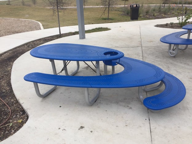 This picnic bench that includes a high chair, seating for small children, seating for a adults, AND space for wheelchair users.