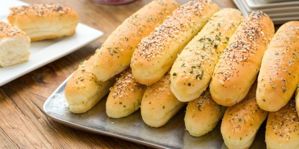 When traveling to Italy don't be expecting to see the usual staple most Americans order at their local Olive Garden or Little Caesars. Though you may find breadsticks in Italy, they will be quite different than you're used to. Breadsticks are usually the size of pencils and are very crisp, much like croutons for Americans. The history of breadsticks in Italy is fascinating! "Grissini, or Traditional Italian Bread Sticks, originated in Torino in Piemonte, a region of northwest Italy. Grissini were actually invented around the end of the 17th century to cure the health problems of young Duke Vittorio Amedeo II of Savoy. The duke had difficulty digesting most foods and Don Baldo di Lanzo, the court doctor, commissioned a baker from Torino, Antonio Brunero, to create something that the young duke could digest. Antonio decided to take a part of the dough used to make ghersa, a typical bread of Torino, and stretch it out into long, thin strips. Once baked, the thin bread sticks were crisp and easy to digest. His creation was a great success and became so popular, it entered the daily life of the Torinesi - and later the whole of Italy. Among the greatest fans of grissini was Napoleon Bonaparte, who at the beginning of the 19th century, founded a stagecoach service between Torino and Paris mostly dedicated to delivering him what he called les petits batons de Turin, “ little sticks of Turin”." http://www.claudiosspecialtybreads.com/history.html