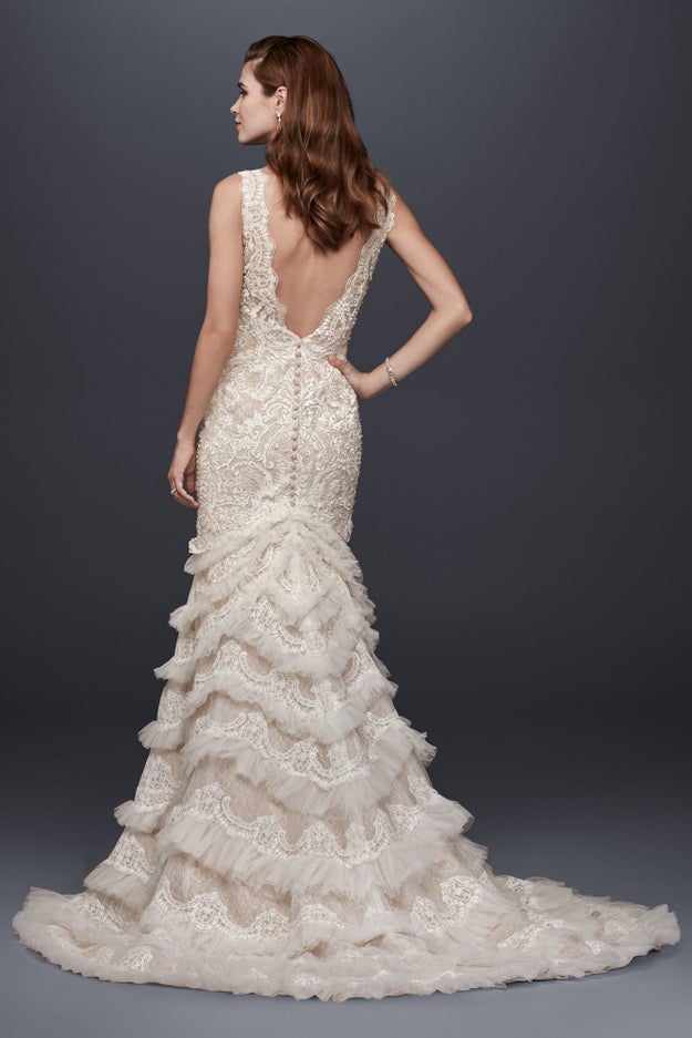 The incredible scalloped-lace and ruffled-tulle trumpet skirt on an ornate gown by David's Bridal.