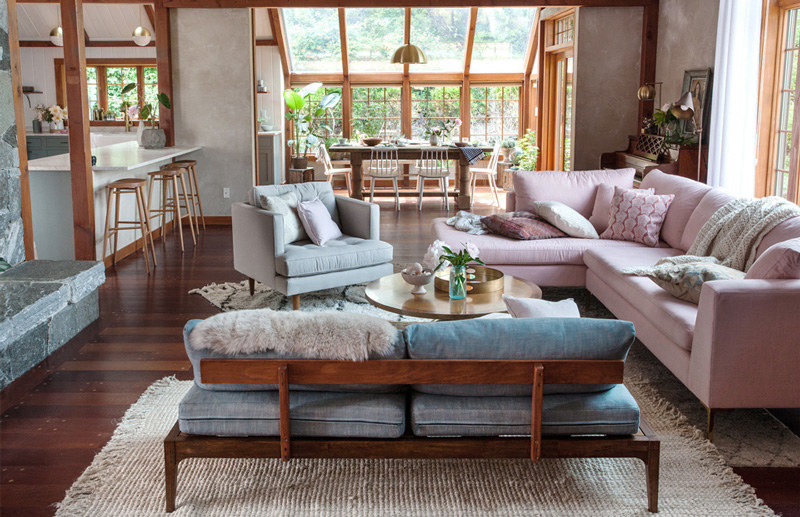 The pink sofa adds a light color into space and matches the blue color very well.