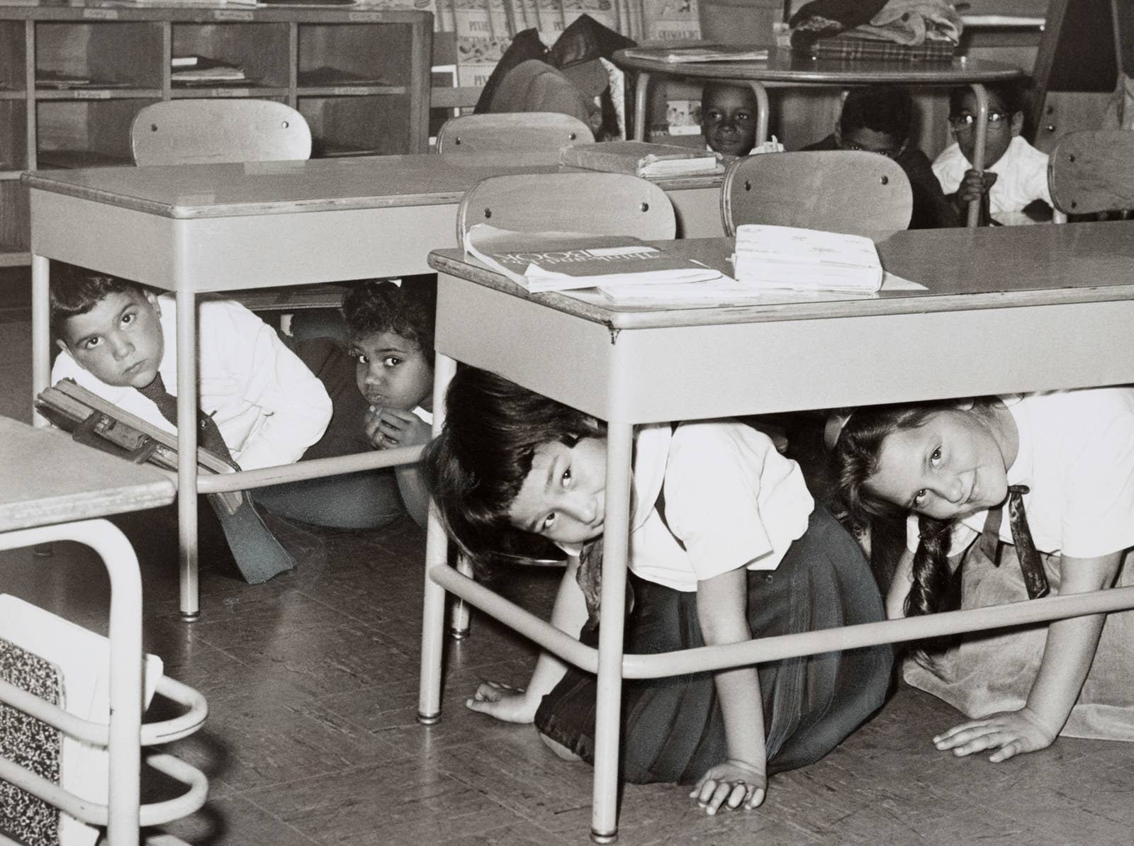 Students at a Brooklyn middle school in 1962 conduct a duck-and-cover practice drill in preparation for a nuclear attack.