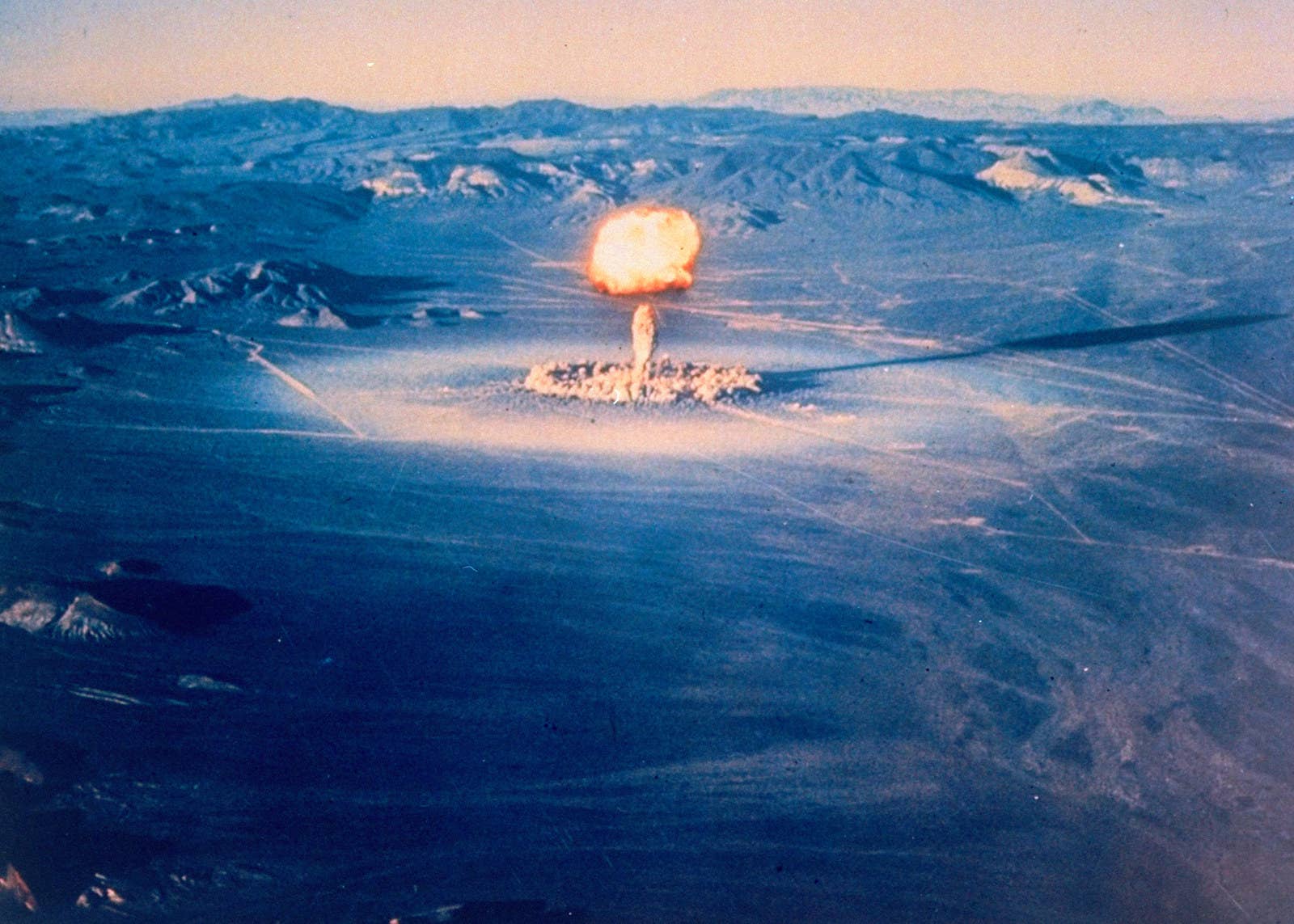 An atomic cloud rises over the desert after an atomic bomb detonation in 1951.