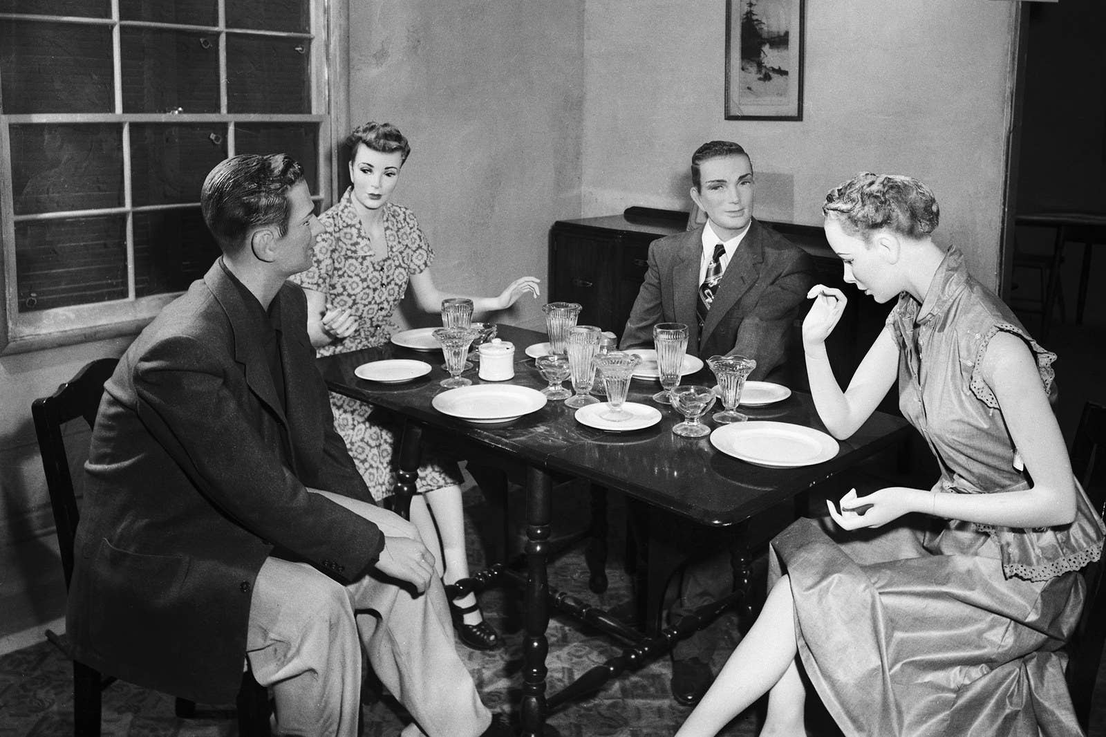 Plastic dummies are arranged by the US government in a casual dinner scene in an average American home located almost two miles from where an atomic bomb was scheduled to explode on March 17, 1953.