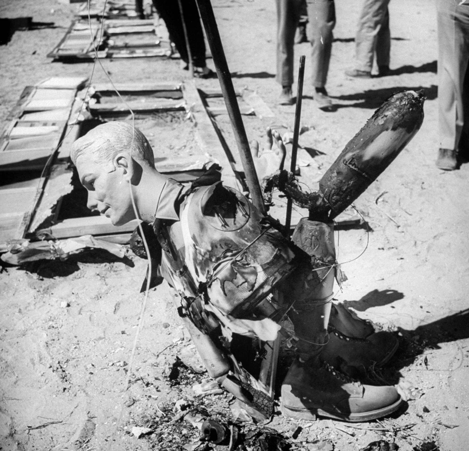 Dummies are used to show the effects of an A-bomb during a test in the desert in 1955.