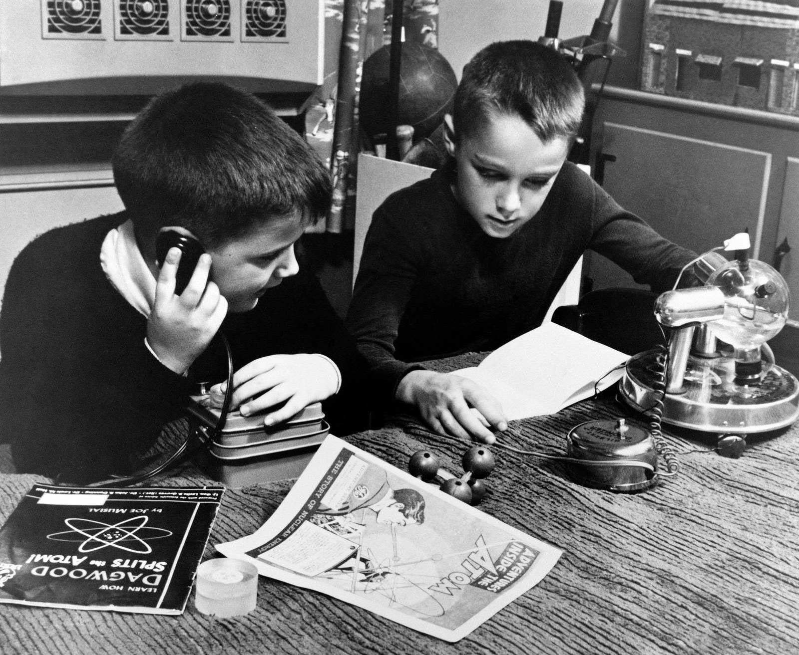 Two boys play with atomic-themed toys during the early 1960s.