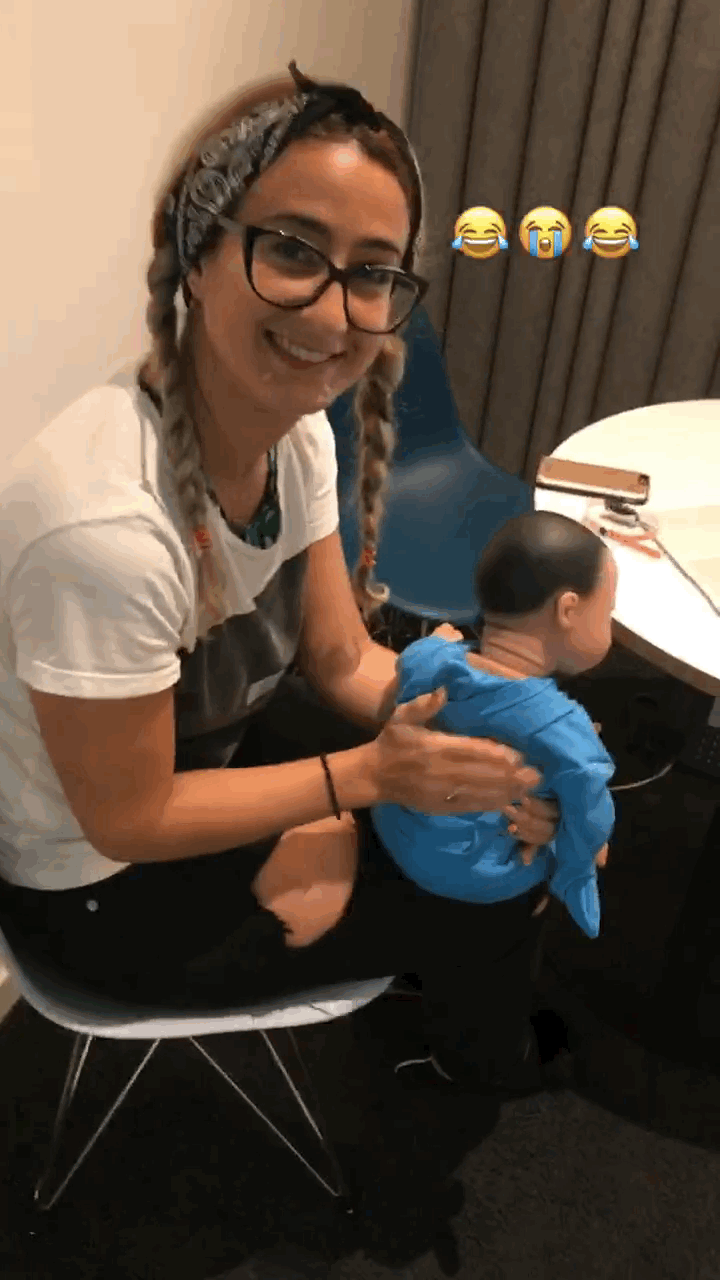 You can see me mouthing "horrible" as my coworker asks how motherhood is going for me.