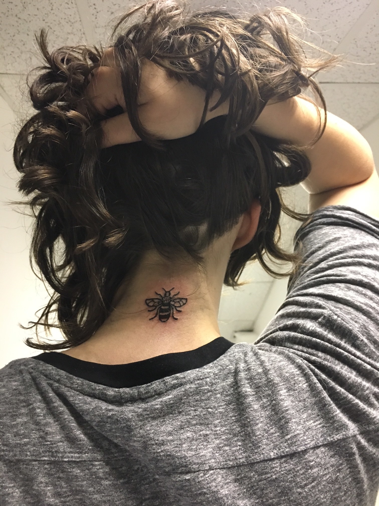 Attractive Bumblebee Tattoo On Back Neck