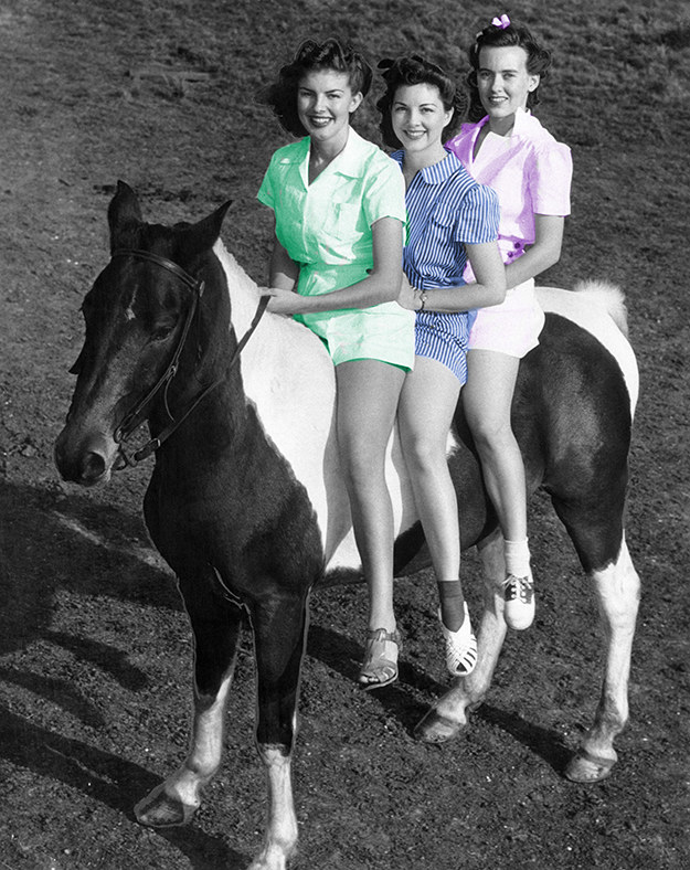 three women sitting on a mini horse